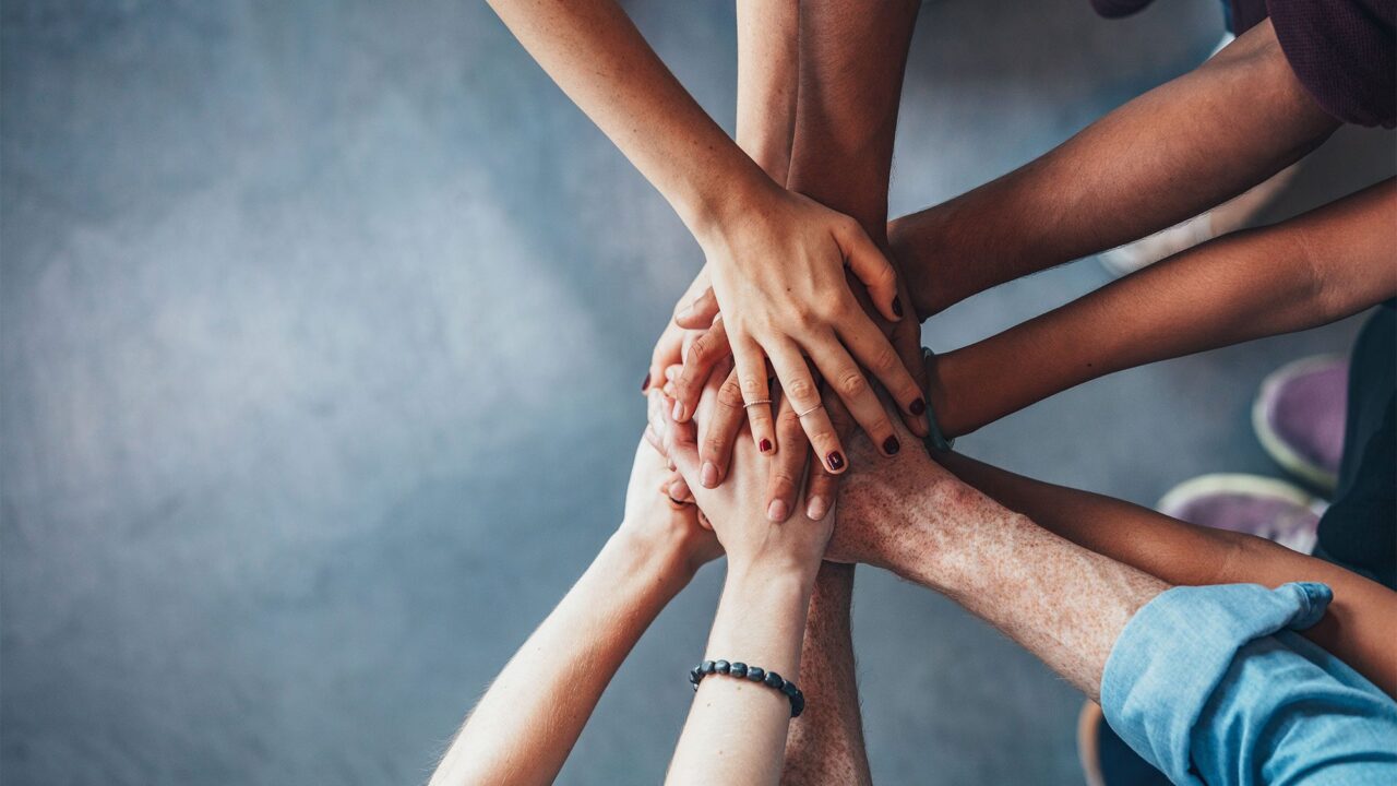 Hands in a circle on top of each other