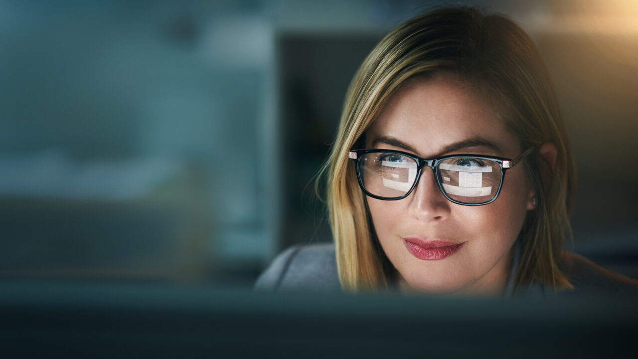 Shot of a young businesswoman working late on a computer in an office