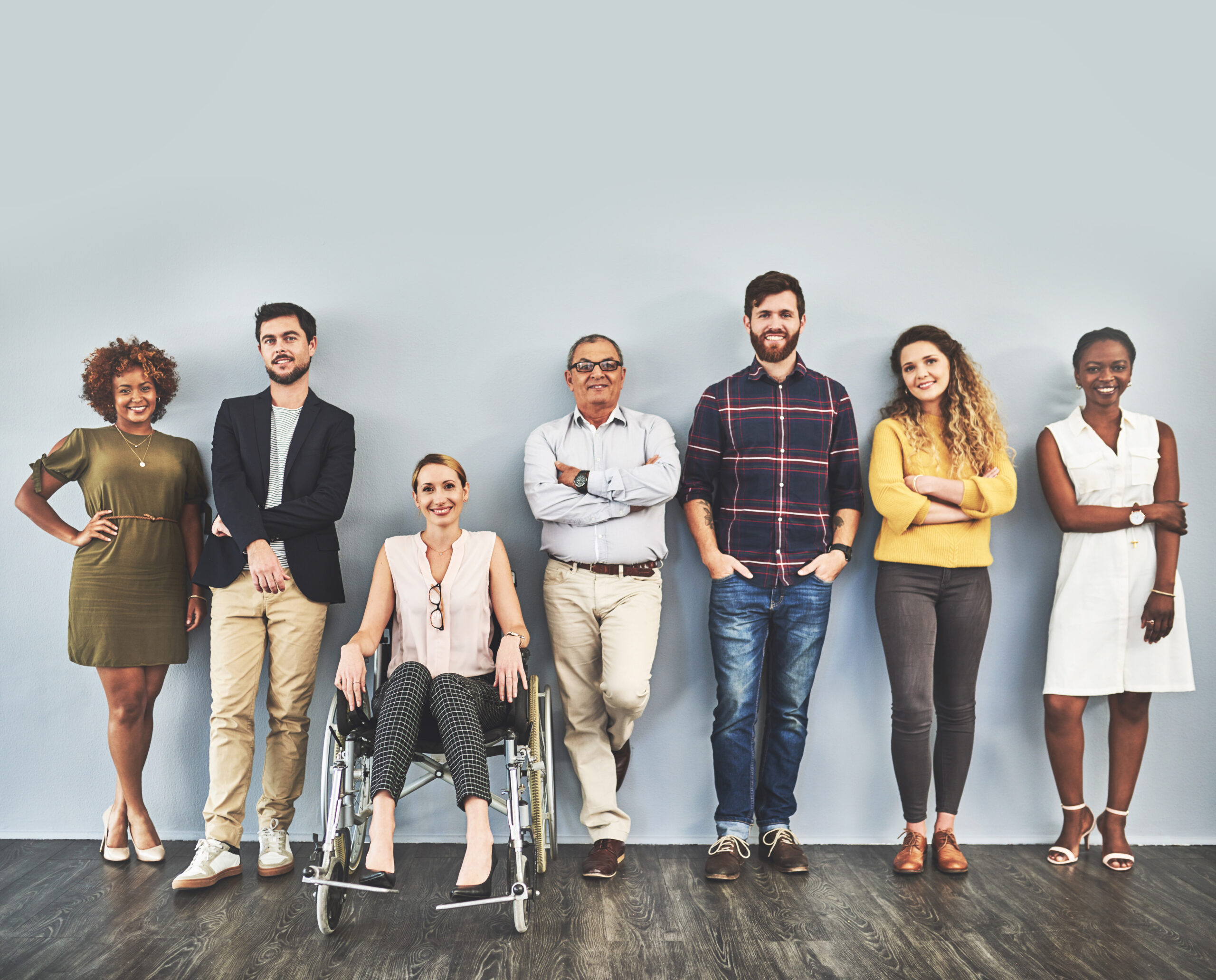 Shot of a diverse group of businesspeople standing against a wall