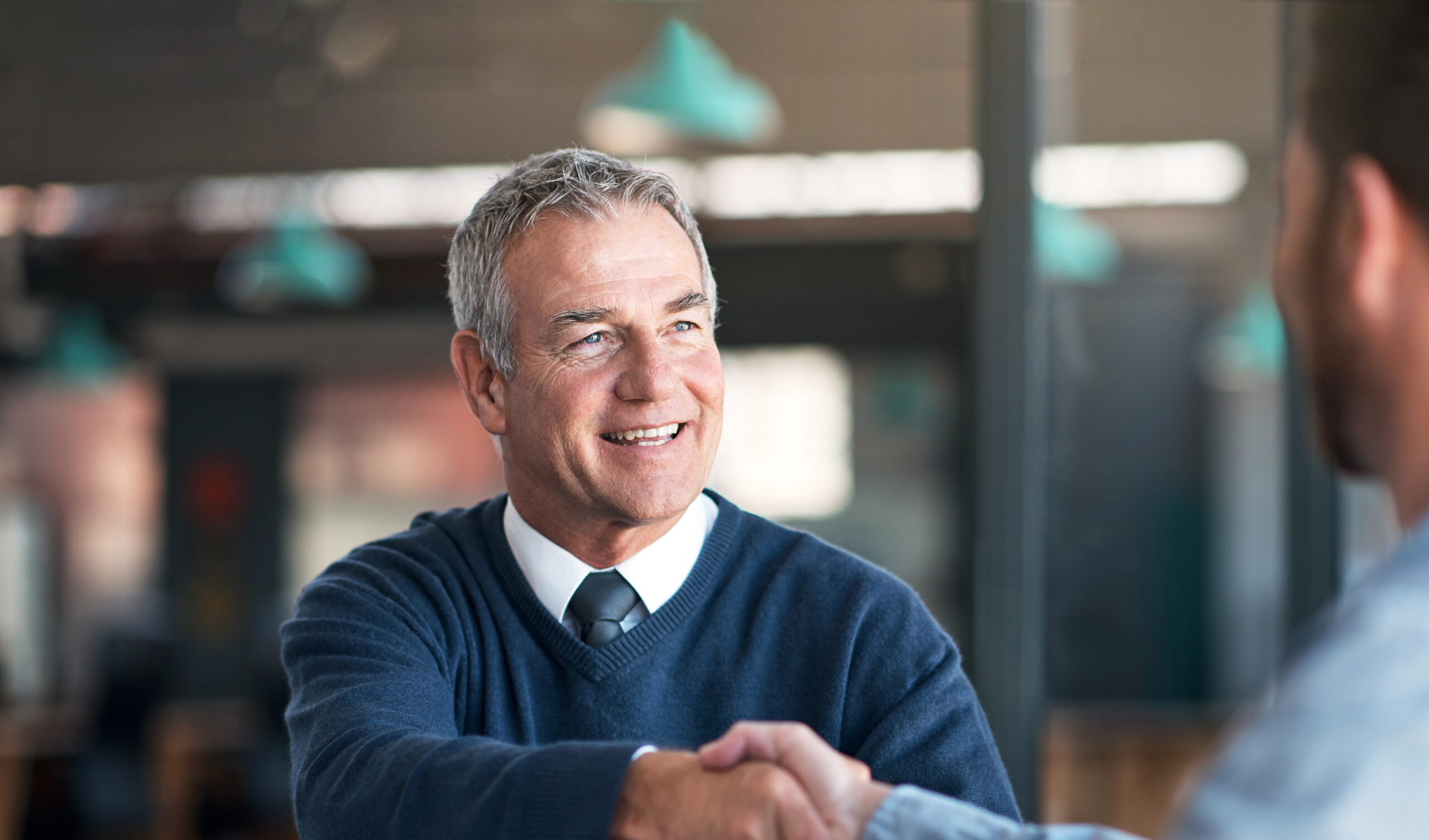 Shot of two businessmen shaking hands in an office