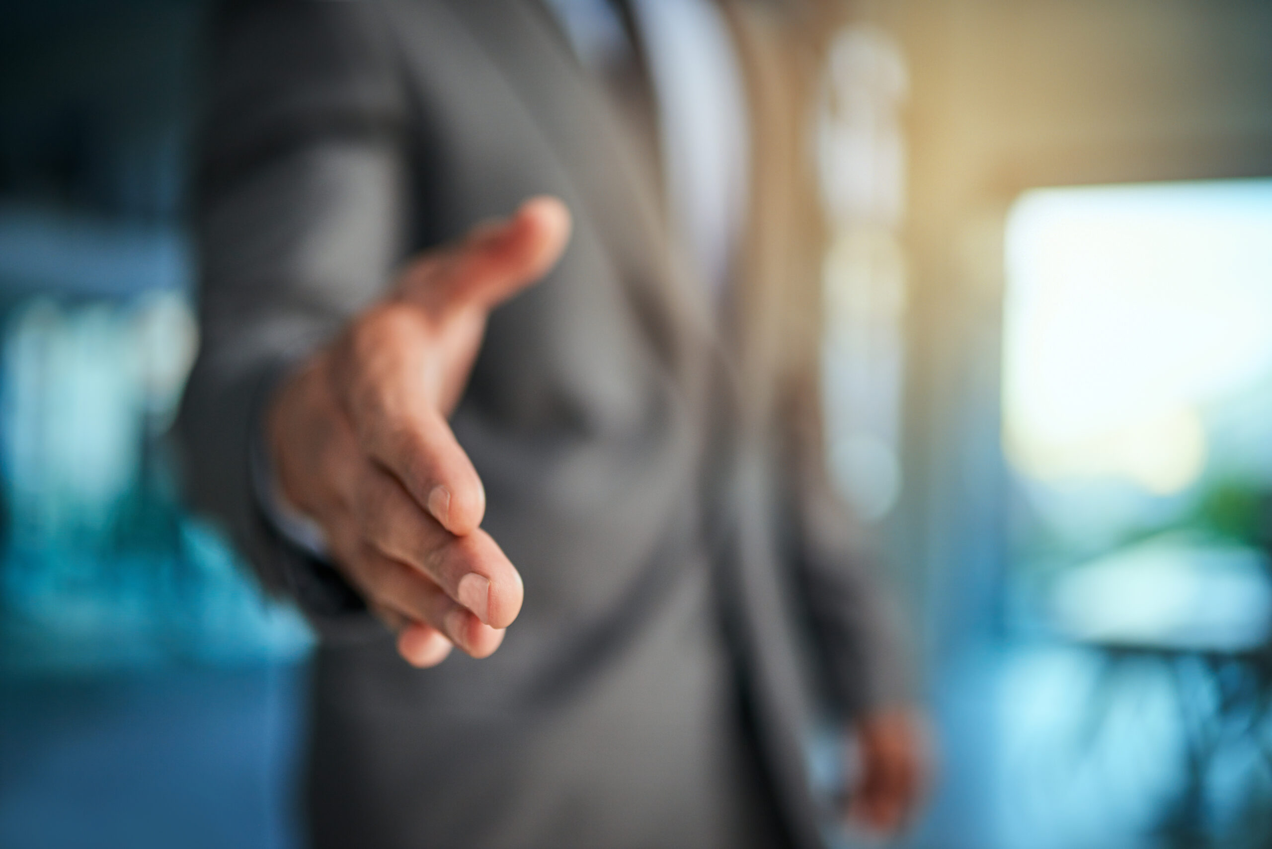 Cropped shot of a businessman extending his arm for a handshake