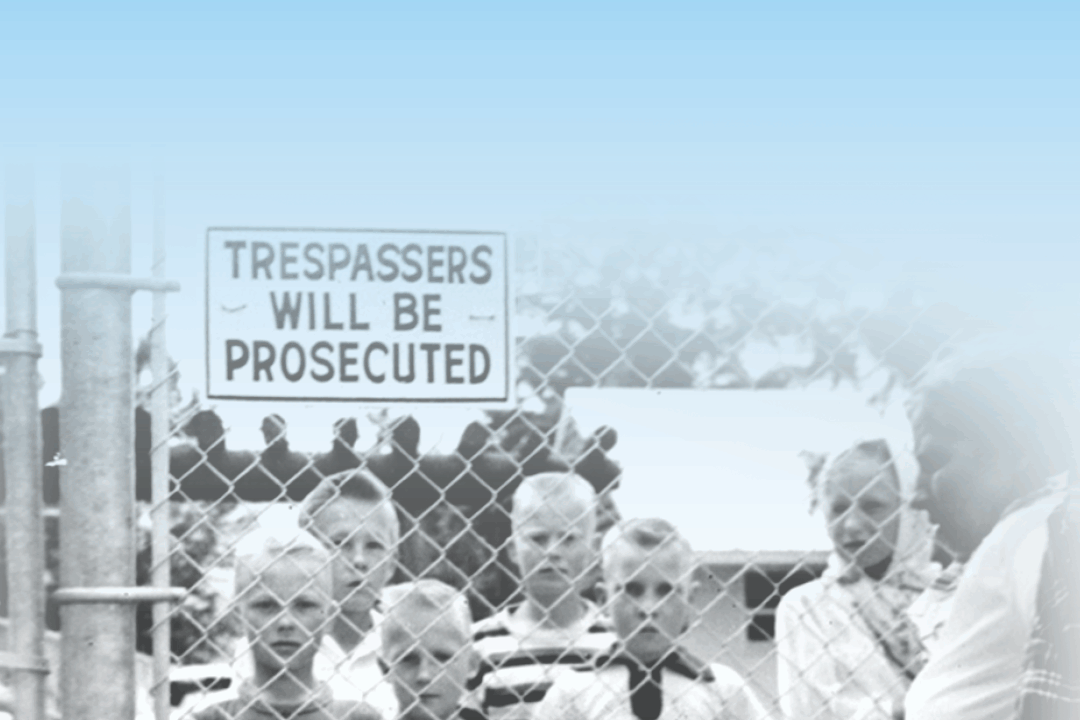 Old school image of kids behind a trespassers will be prosecuted sign