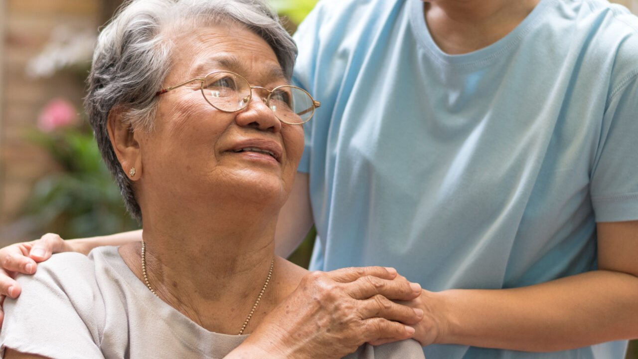 Caregiver, carer hand holding elder hand woman in hospice care. Philanthropy kindness to disabled concept.Public Service Recognition Week