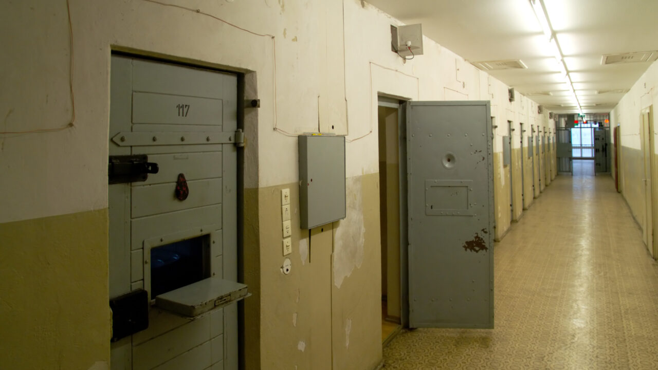 Hallway with an open cell in an abandoned prison in the eastern part of Berlin