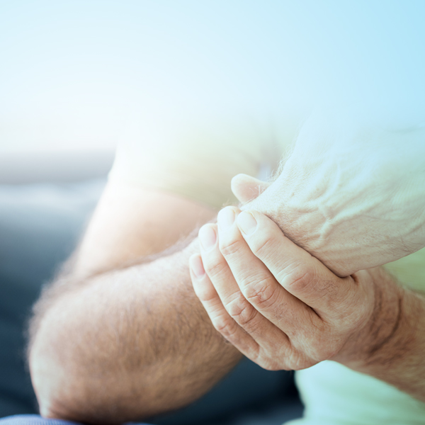 Person grasping wrist in pain
