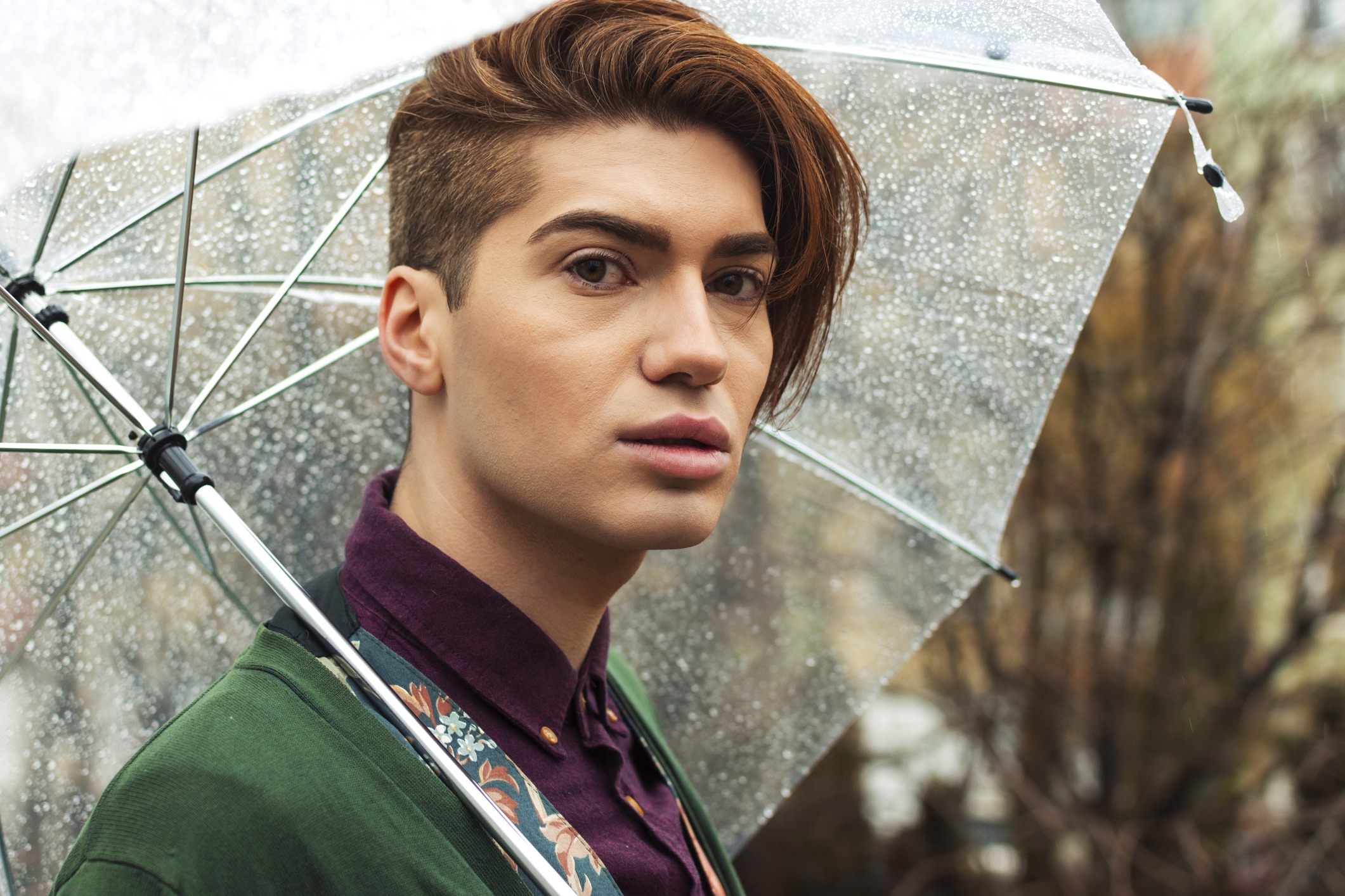 Young man around the city in a rainy day