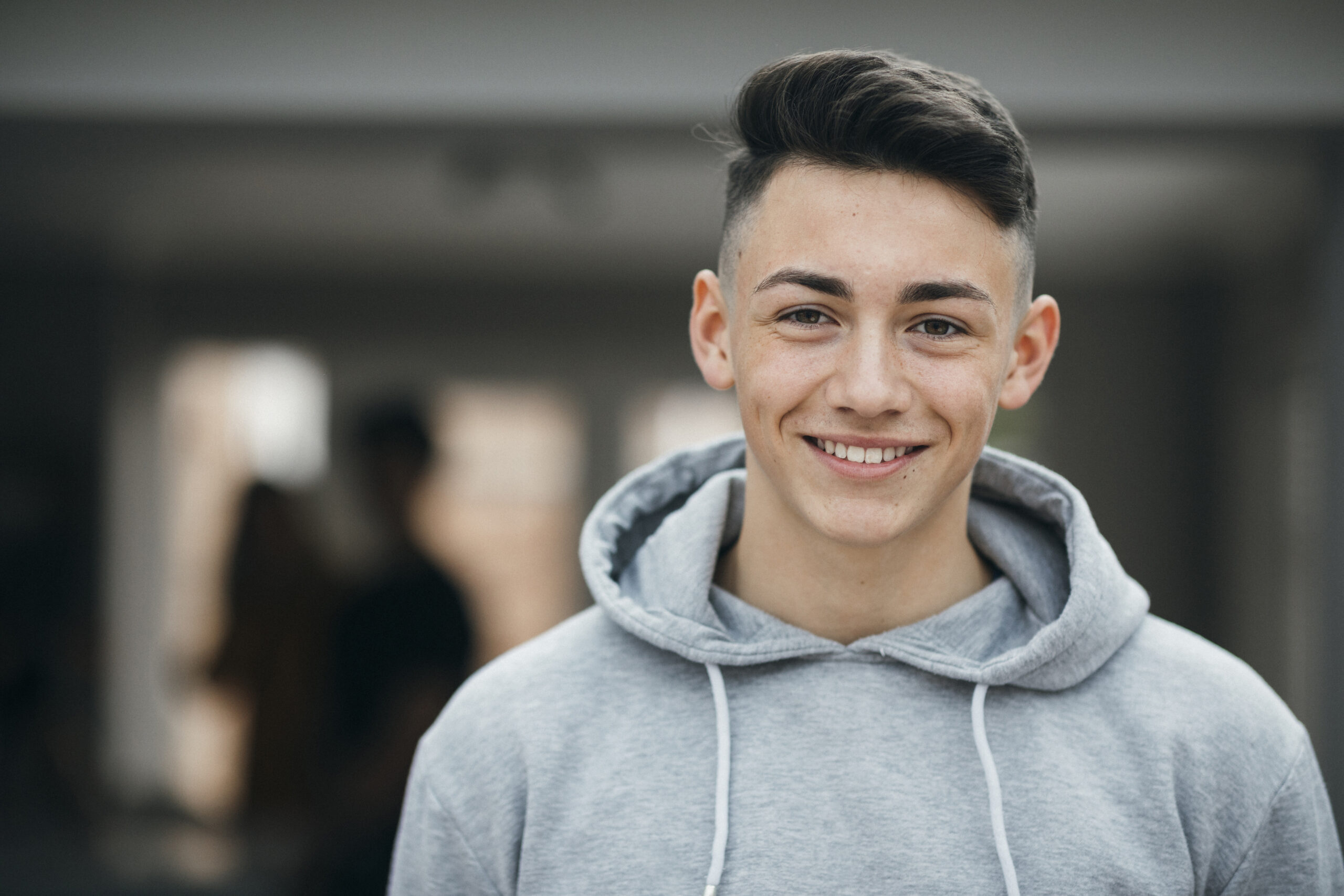 Portrait of a smiling teenager looking at the camera and smiling.
