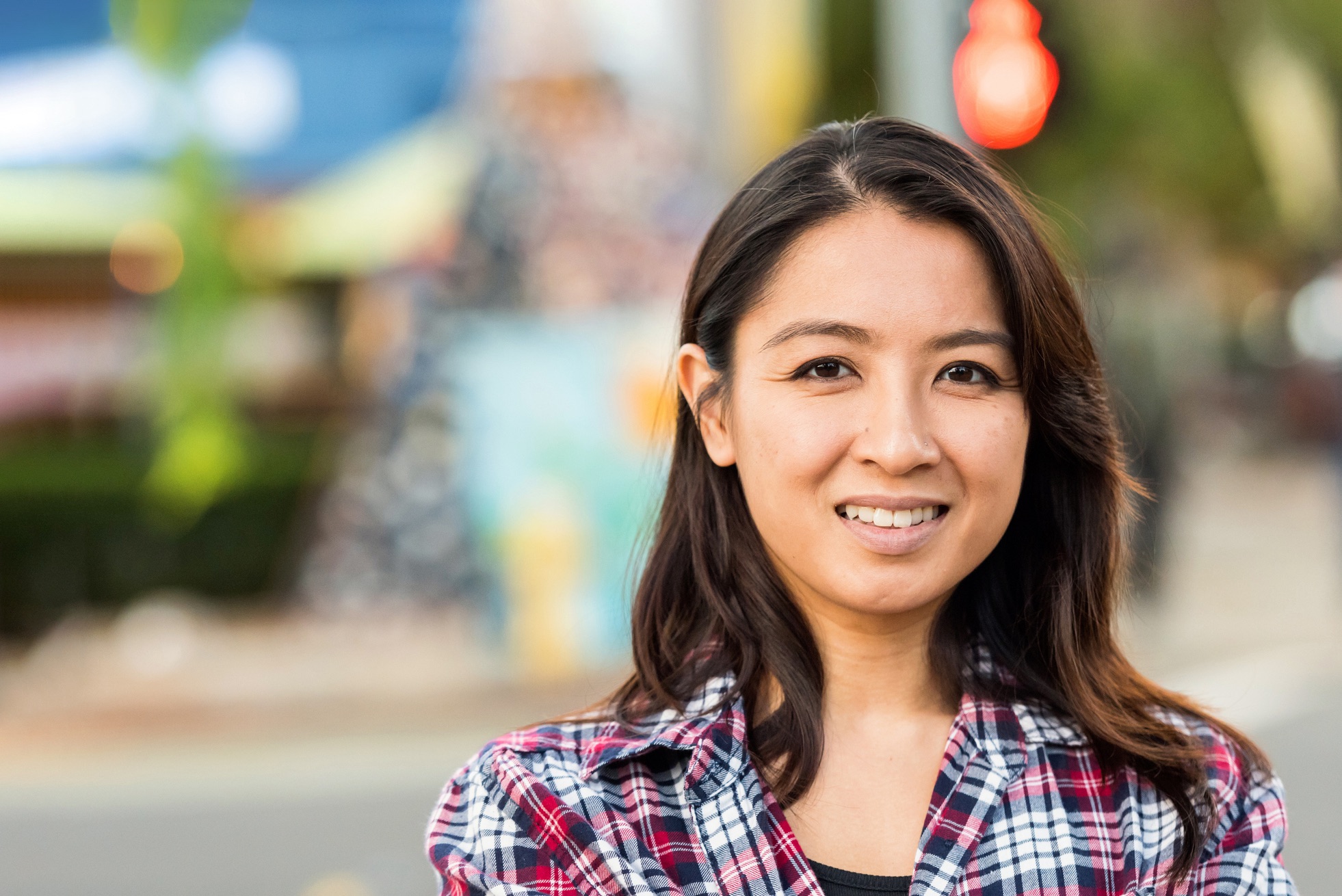 Smiling mid adult asian woman looking at the camera