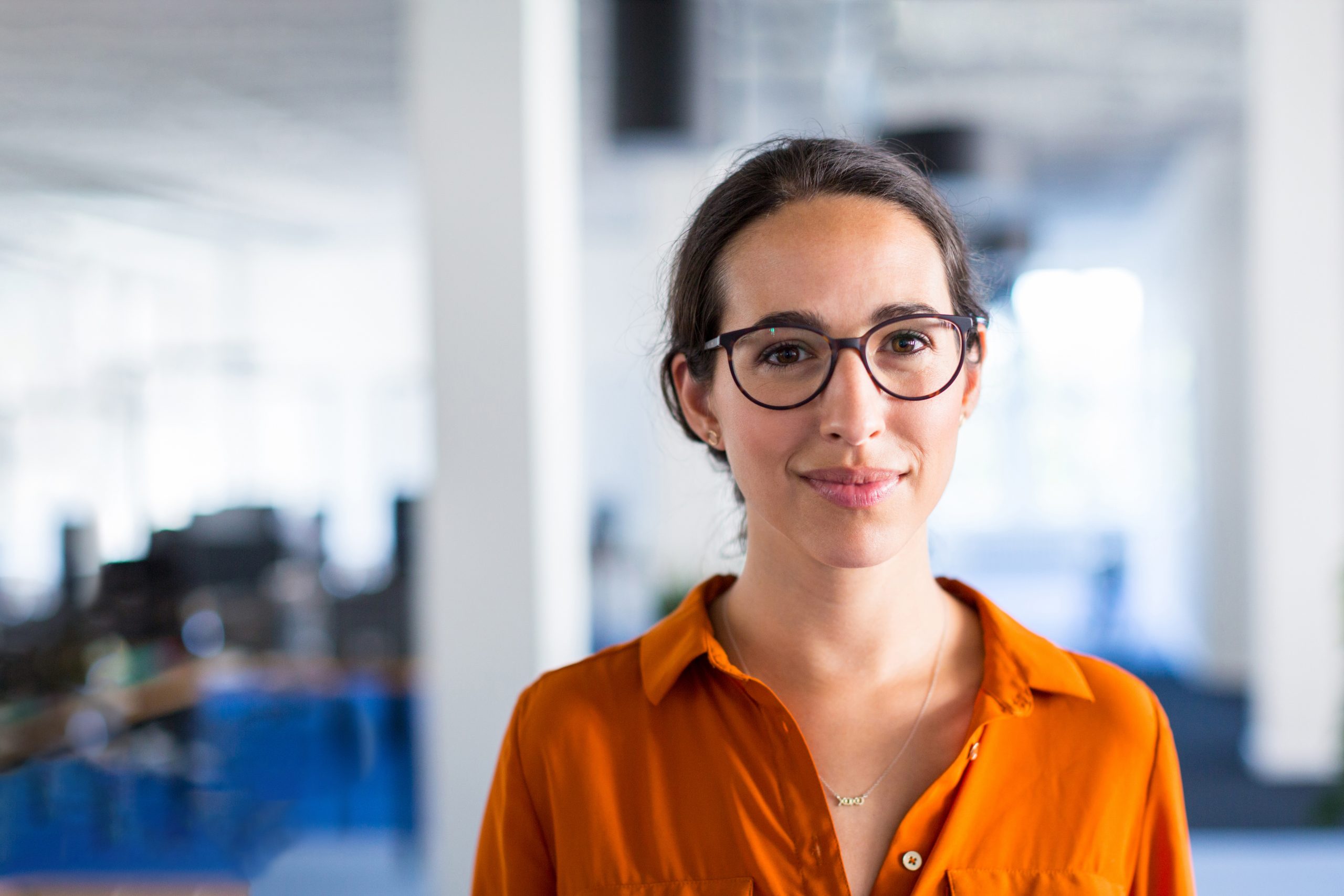 Woman in office smiling at camera